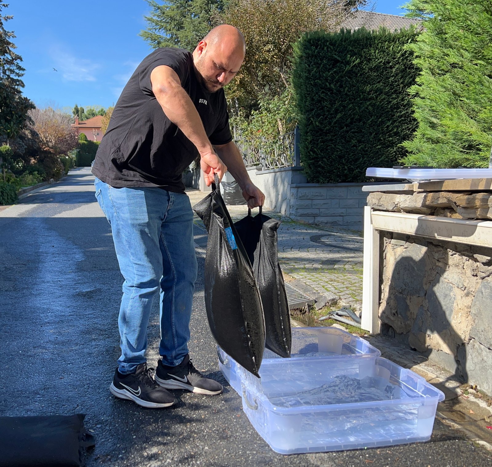 SUPER BLOC flood bag being dipped in water for activation