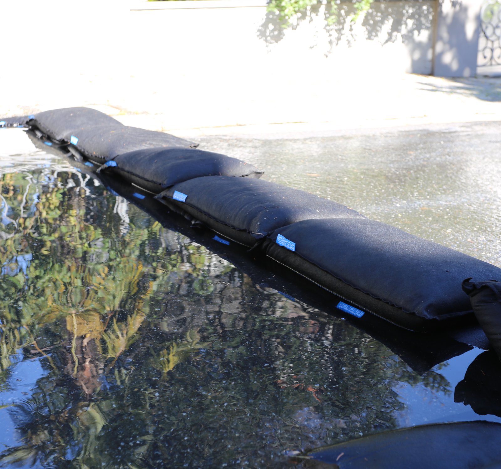 Stacked SUPER BLOC flood bags holding back water