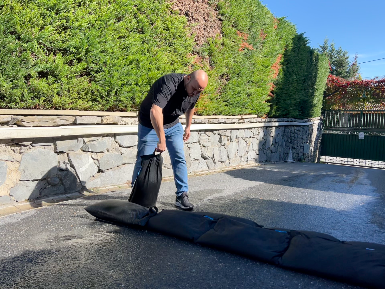 Deploying SUPER BLOC bags to form a flood barrier